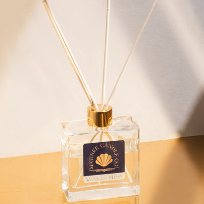 The classic reed diffuser in Vanilla Noir against an ivory and gold background